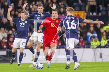 2023-03-28 - Rodri of Spain and Lyndon Dykes, Liam Cooper of Scotland during the UEFA Euro 2024, European Qualifiers, Group A football match between Scotland and Spain on March 28, 2023 at Hampden Park in Glasgow, Scotland - FOOTBALL - EURO 2024 - QUALIFYING - SCOTLAND V SPAIN - UEFA EUROPEAN - SOCCER