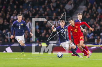 2023-03-28 - Dani Ceballos of Spain and Ryan Christie of Scotland during the UEFA Euro 2024, European Qualifiers, Group A football match between Scotland and Spain on March 28, 2023 at Hampden Park in Glasgow, Scotland - FOOTBALL - EURO 2024 - QUALIFYING - SCOTLAND V SPAIN - UEFA EUROPEAN - SOCCER