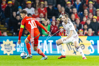 2023-03-28 - Wales' midfielder Aaron Ramsey (10) under pressure from Latvian midfielder Arturs Zjuzins (17) during the UEFA Euro 2024, European Qualifiers football match between Wales and Latvia on 28 March 2023 at the Cardiff City Stadium in Cardiff, Wales - FOOTBALL - EURO 2024 - QUALIFYING - WALES V LATVIA - UEFA EUROPEAN - SOCCER