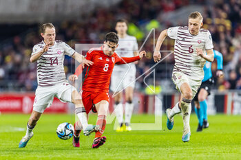 2023-03-28 - Wales' midfielder Harry Wilson (8) under pressure from Latvian midfielder Andrejs Ciganiks (14) and Latvian midfielder Kristers Tobers (6) during the UEFA Euro 2024, European Qualifiers football match between Wales and Latvia on 28 March 2023 at the Cardiff City Stadium in Cardiff, Wales - FOOTBALL - EURO 2024 - QUALIFYING - WALES V LATVIA - UEFA EUROPEAN - SOCCER