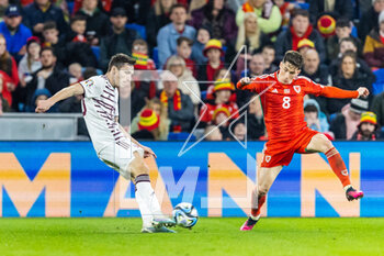 2023-03-28 - Latvian defender Raivis Jurkovskis (13) under pressure from Wales' midfielder Harry Wilson (8) during the UEFA Euro 2024, European Qualifiers football match between Wales and Latvia on 28 March 2023 at the Cardiff City Stadium in Cardiff, Wales - FOOTBALL - EURO 2024 - QUALIFYING - WALES V LATVIA - UEFA EUROPEAN - SOCCER