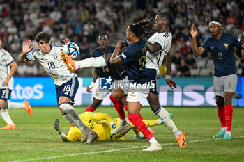 2023-06-22 - Italy U21’s Caleb Okoli trying to stop the ball during the first qualifying round UEFA European Under-21 Championship 2023 soccer match Italy U21 vs. France U21 at the Cluj Arena stadium in Cluj Napoca, Romania, 22nd of June 2023 - UNDER 21 MEN - FRANCE VS ITALY - UEFA EUROPEAN - SOCCER