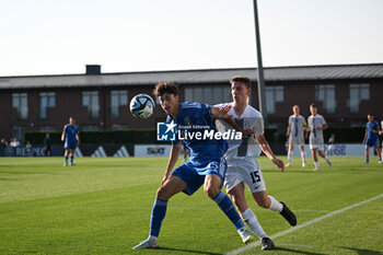 2023-05-24 - Italy U17’s Alessandro Bassino and Slovenia U17’s Gabriel Sojer during the qualifying phase Under-17 Championship Hungary 2023 soccer match Italy U17 vs. Slovenia U17 at the Globall Football Park stadium in Telki, Hungary, 24th of May 2023 - UNDER 17 MEN - SLOVENIA VS ITALY - UEFA EUROPEAN - SOCCER