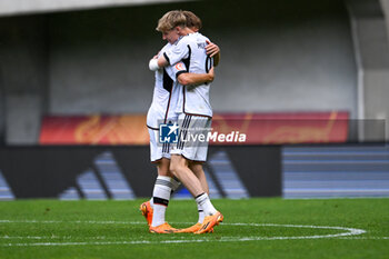 2023-05-30 - Germany U17’s Max Moerstedt hugs teammate at the end of the qualifying phase Under-17 Championship Hungary 2023 soccer match Poland U17 vs. Germany U17 at the Pancho Arena stadium in Felcsut, Hungary, 30rd of May 2023 - U17 - POLAND U17 VS GERMANY U17 - UEFA EUROPEAN - SOCCER