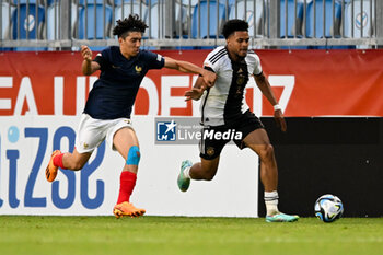 2023-06-02 - France U17’s Mohammed-Amine Boucehnna try to stop Germany U17’s Almugera Kabar during the final phase Under-17 Championship Hungary 2023 soccer match Germany U17 vs. France U17 at the Nandor Hidegkuti Stadion stadium in Budapest, Hungary, 2nd of June 2023 - UNDER 17 FINAL - GERMANY VS FRANCE - UEFA EUROPEAN - SOCCER