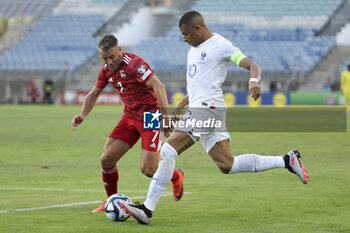 2023-06-16 - Kylian Mbappe of France, left Lee Casciaroa of Gibraltar during the UEFA Euro 2024, European Qualifiers, Group B, football match between Gibraltar and France on June 16, 2023 at Estadio Algarve in Faro, Portugal - FOOTBALL - EURO 2024 - QUALIFYING - GIBRALTAR V FRANCE - UEFA EUROPEAN - SOCCER