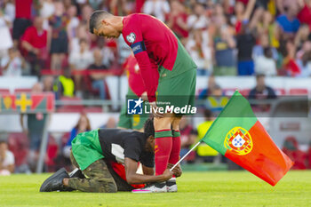 2023-06-17 - A Portugal fan invades the pitch and grabs Cristiano Ronaldo's feet during the UEFA Euro 2024, European Qualifiers, Group J, football match between Portugal and Bosnia and Herzegovina on June 17, 2023 at Estádio do SL Benfica in Lisbon, Portugal - FOOTBALL - EURO 2024 - QUALIFYING - PORTUGAL V BOSNIA HERZEGOVINA - UEFA EUROPEAN - SOCCER
