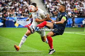 2023-06-19 - Konstantinos MAVROPANOS of Greece and Kylian MBAPPE of France during the UEFA Euro 2024, European Qualifiers, Group B, football match between France and Greece on June 19, 2023 at Stade de France in Saint-Denis, France - FOOTBALL - EURO 2024 - QUALIFYING - FRANCE V GREECE - UEFA EUROPEAN - SOCCER