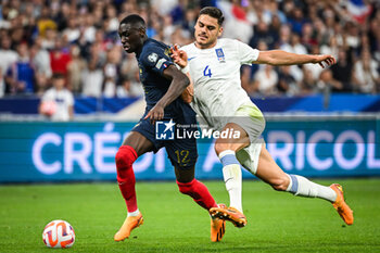 2023-06-19 - Randal KOLO MUANI of France and Konstantinos MAVROPANOS of Greece during the UEFA Euro 2024, European Qualifiers, Group B, football match between France and Greece on June 19, 2023 at Stade de France in Saint-Denis, France - FOOTBALL - EURO 2024 - QUALIFYING - FRANCE V GREECE - UEFA EUROPEAN - SOCCER