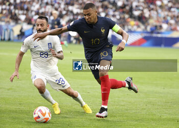 2023-06-19 - Kylian Mbappe of France, left Manolis Siopis of Greece during the UEFA Euro 2024, European Qualifiers, Group B, football match between France and Greece on June 19, 2023 at Stade de France in Saint-Denis, France - FOOTBALL - EURO 2024 - QUALIFYING - FRANCE V GREECE - UEFA EUROPEAN - SOCCER