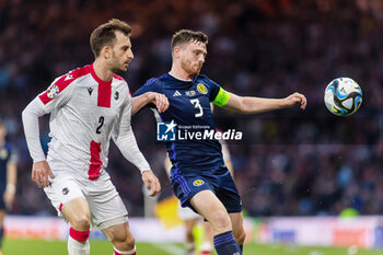 2023-06-20 - Andrew Robertson of Scotland and Otar Kakabadze of Georgia during the UEFA Euro 2024, European Qualifiers, Group A football match between Scotland and Georgia on 20 June 2023 at Hampden Park in Glasgow, Scotland - FOOTBALL - EURO 2024 - QUALIFYING - SCOTLAND V GEORGIA - UEFA EUROPEAN - SOCCER