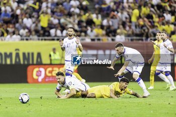 2023-09-13 - Florinel Coman of Romania being tackled by Amir Rrahmani of Kosovo causing a penalty during the UEFA Euro 2024, European Qualifiers, Group I football match between Romania and Kosovo on September 12, 2023 at Arena Nationala in Bucharest, Romania - FOOTBALL - EURO 2024 - QUALIFYING - ROMANIA V KOSOVO - UEFA EUROPEAN - SOCCER