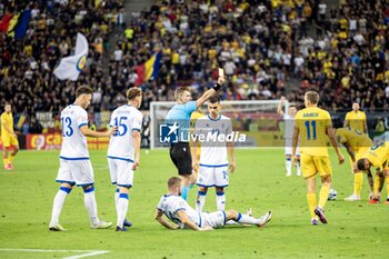 2023-09-13 - Referee Willy Delajod showing Nicusor Bancu of Romania the yellow card during the UEFA Euro 2024, European Qualifiers, Group I football match between Romania and Kosovo on September 12, 2023 at Arena Nationala in Bucharest, Romania - FOOTBALL - EURO 2024 - QUALIFYING - ROMANIA V KOSOVO - UEFA EUROPEAN - SOCCER