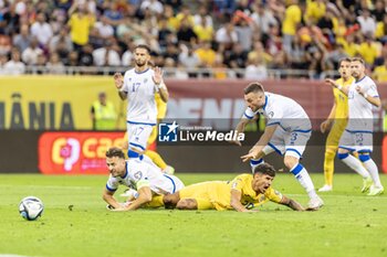 2023-09-13 - Florinel Coman of Romania being tackled by Amir Rrahmani of Kosovo causing a penalty during the UEFA Euro 2024, European Qualifiers, Group I football match between Romania and Kosovo on September 12, 2023 at Arena Nationala in Bucharest, Romania - FOOTBALL - EURO 2024 - QUALIFYING - ROMANIA V KOSOVO - UEFA EUROPEAN - SOCCER