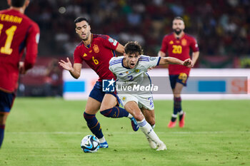 2023-10-12 - Mikel Merino of Spain and Aaron Hickey of Scotland during the UEFA EURO 2024, European Qualifiers Group A football match between Spain and Scotland on October 12, 2023 at La Cartuja stadium in Sevilla, Spain - FOOTBALL - EURO 2024 - QUALIFYING - SPAIN V SCOTLAND - UEFA EUROPEAN - SOCCER