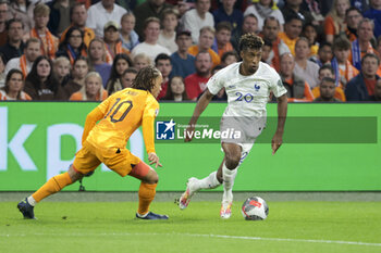 2023-10-13 - Kingsley Coman of France, left Xavi Simons of Netherlands during the UEFA Euro 2024, Qualifiers Group B football match between Netherlands and France on October 13, 2023 at Johan Cruijff ArenA in Amsterdam, Netherlands - FOOTBALL - EURO 2024 - QUALIFYING - NETHERLANDS V FRANCE - UEFA EUROPEAN - SOCCER