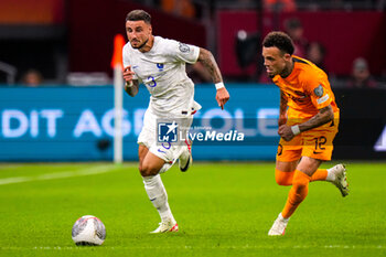 2023-10-13 - Jonathan Clauss of France and Quilindschy Hartman of the Netherlands during the UEFA Euro 2024, Qualifiers Group B football match between Netherlands and France on October 13, 2023 at Johan Cruijff ArenA in Amsterdam, Netherlands - FOOTBALL - EURO 2024 - QUALIFYING - NETHERLANDS V FRANCE - UEFA EUROPEAN - SOCCER