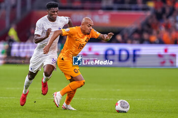 2023-10-13 - Donyell Malen of the Netherlands is challenged by Aurelien Tchouameni of France during the UEFA Euro 2024, Qualifiers Group B football match between Netherlands and France on October 13, 2023 at Johan Cruijff ArenA in Amsterdam, Netherlands - FOOTBALL - EURO 2024 - QUALIFYING - NETHERLANDS V FRANCE - UEFA EUROPEAN - SOCCER