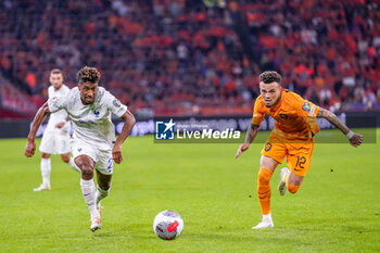 2023-10-13 - Kingsley Coman of France is challenged by Quilindschy Hartman of the Netherlands during the UEFA Euro 2024, Qualifiers Group B football match between Netherlands and France on October 13, 2023 at Johan Cruijff ArenA in Amsterdam, Netherlands - FOOTBALL - EURO 2024 - QUALIFYING - NETHERLANDS V FRANCE - UEFA EUROPEAN - SOCCER