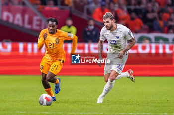 2023-10-13 - Jeremie Frimpong of the Netherlands is challenged by Theo Hernandez of France during the UEFA Euro 2024, Qualifiers Group B football match between Netherlands and France on October 13, 2023 at Johan Cruijff ArenA in Amsterdam, Netherlands - FOOTBALL - EURO 2024 - QUALIFYING - NETHERLANDS V FRANCE - UEFA EUROPEAN - SOCCER
