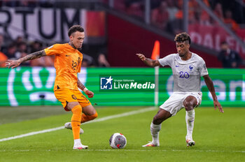 2023-10-13 - Quilindschy Hartman of the Netherlands is challenged by Kingsley Coman of France during the UEFA Euro 2024, Qualifiers Group B football match between Netherlands and France on October 13, 2023 at Johan Cruijff ArenA in Amsterdam, Netherlands - FOOTBALL - EURO 2024 - QUALIFYING - NETHERLANDS V FRANCE - UEFA EUROPEAN - SOCCER
