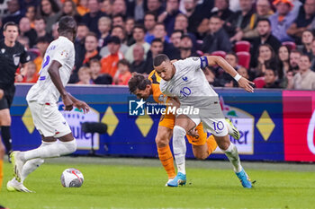 2023-10-13 - Kylian Mbappe of France is challenged by Marten de Roon of the Netherlands during the UEFA Euro 2024, Qualifiers Group B football match between Netherlands and France on October 13, 2023 at Johan Cruijff ArenA in Amsterdam, Netherlands - FOOTBALL - EURO 2024 - QUALIFYING - NETHERLANDS V FRANCE - UEFA EUROPEAN - SOCCER