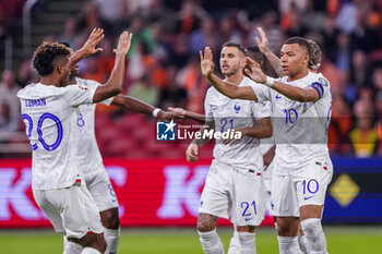 2023-10-13 - Kylian Mbappe of France celebrates after scoring her sides first goal with Kingsley Coman during the UEFA Euro 2024, Qualifiers Group B football match between Netherlands and France on October 13, 2023 at Johan Cruijff ArenA in Amsterdam, Netherlands - FOOTBALL - EURO 2024 - QUALIFYING - NETHERLANDS V FRANCE - UEFA EUROPEAN - SOCCER