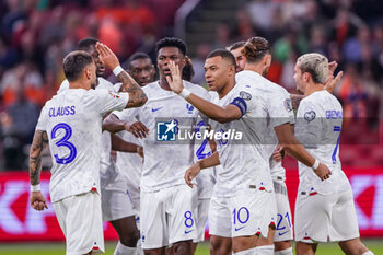 2023-10-13 - Kylian Mbappe of France celebrates after scoring her sides first goal with Jonathan Clauss of France and Aurelien Tchouameni of France during the UEFA Euro 2024, Qualifiers Group B football match between Netherlands and France on October 13, 2023 at Johan Cruijff ArenA in Amsterdam, Netherlands - FOOTBALL - EURO 2024 - QUALIFYING - NETHERLANDS V FRANCE - UEFA EUROPEAN - SOCCER