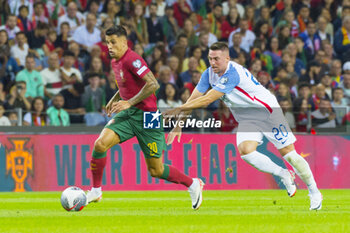 2023-10-13 - Joao Cancelo of Portugal and Robert Mak of Slovakia during the UEFA Euro 2024, European Qualifiers, Group J, football match between Portugal and Slovakia on October 13, 2023 at Estadio do Dragao in Porto, Portugal - FOOTBALL - EURO 2024 - QUALIFYING - PORTUGAL V SLOVAKIA - UEFA EUROPEAN - SOCCER
