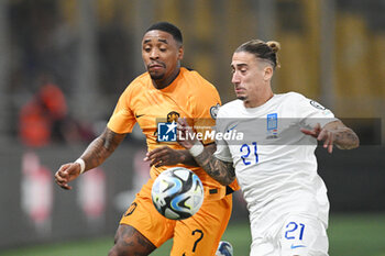 2023-10-16 - Steven Bergwijn of the Netherlands and Kostas Tsimikas of Greece during the UEFA Euro 2024, Qualifiers Group B football match between Greece and Netherlands on October 16, 2023 at OPAP Arena in Athens, Greece - FOOTBALL - EURO 2024 - QUALIFYING - GREECE V NETHERLANDS - UEFA EUROPEAN - SOCCER