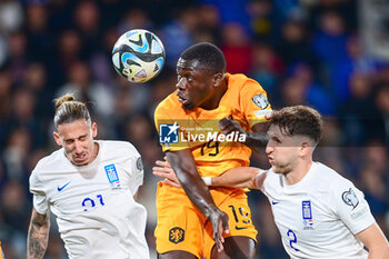 2023-10-16 - Brian Brobbey of the Netherlands and Kostas Tsimikas, Panagiotis Retsos of Greece during the UEFA Euro 2024, Qualifiers Group B football match between Greece and Netherlands on October 16, 2023 at OPAP Arena in Athens, Greece - FOOTBALL - EURO 2024 - QUALIFYING - GREECE V NETHERLANDS - UEFA EUROPEAN - SOCCER