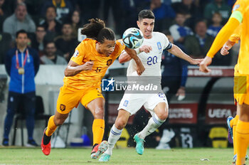 2023-10-16 - Nathan Ake of the Netherlands battles for possession with Petros Mantalos of Greece during the UEFA Euro 2024, Qualifiers Group B football match between Greece and Netherlands on October 16, 2023 at OPAP Arena in Athens, Greece - FOOTBALL - EURO 2024 - QUALIFYING - GREECE V NETHERLANDS - UEFA EUROPEAN - SOCCER