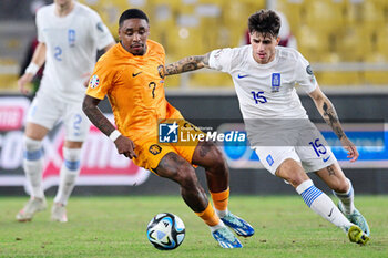 2023-10-16 - Steven Bergwijn of the Netherlands battles for possession with Lazaros Rota of Greece during the UEFA Euro 2024, Qualifiers Group B football match between Greece and Netherlands on October 16, 2023 at OPAP Arena in Athens, Greece - FOOTBALL - EURO 2024 - QUALIFYING - GREECE V NETHERLANDS - UEFA EUROPEAN - SOCCER