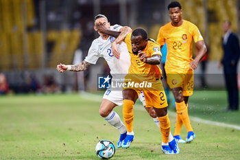 2023-10-16 - Lutsharel Geertruida of the Netherlands battles for possession with Kostas Tsimikas of Greece during the UEFA Euro 2024, Qualifiers Group B football match between Greece and Netherlands on October 16, 2023 at OPAP Arena in Athens, Greece - FOOTBALL - EURO 2024 - QUALIFYING - GREECE V NETHERLANDS - UEFA EUROPEAN - SOCCER
