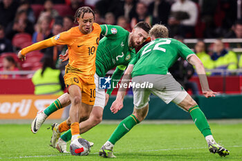 2023-11-18 - Xavi Simons of The Netherlands, Matt Doherty, Nathan Collins of Ireland during the UEFA EURO 2024, Qualifiers Group B football match between Netherlands and Republic of Ireland on November 18, 2023 at Johan Cruijff ArenA in Amsterdam, Netherlands - FOOTBALL - EURO 2024 - QUALIFYING - NETHERLANDS V REPUBLIC OF IRELAND - UEFA EUROPEAN - SOCCER