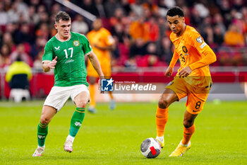 2023-11-18 - Jason Knight of Ireland and Cody Gakpo of The Netherlands during the UEFA EURO 2024, Qualifiers Group B football match between Netherlands and Republic of Ireland on November 18, 2023 at Johan Cruijff ArenA in Amsterdam, Netherlands - FOOTBALL - EURO 2024 - QUALIFYING - NETHERLANDS V REPUBLIC OF IRELAND - UEFA EUROPEAN - SOCCER