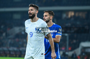 2023-11-21 - 9 Olivier Giroud of France with 17 Pantelis Hatzidiakos of Greece during the European Qualifiers for Euro 24, Group B, match between Greece and France at OPAP Arena on November 21, 2023, in Athens, Greece. - GREECE VS FRANCE, EUROPEAN QUALIFIERS, EURO 2024 - UEFA EUROPEAN - SOCCER