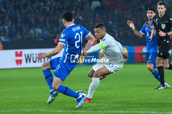 2023-11-21 - 10 Kylian Mbappe of France competing with 21 Manolis Saliakas of Greece during the European Qualifiers for Euro 24, Group B, match between Greece and France at OPAP Arena on November 21, 2023, in Athens, Greece. - GREECE VS FRANCE, EUROPEAN QUALIFIERS, EURO 2024 - UEFA EUROPEAN - SOCCER
