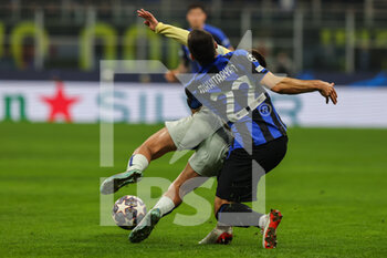 2023-02-22 - Henrikh Mkhitaryan of FC Internazionale competes for the ball with Otavio of FC Porto during the UEFA Champions League 2022/23 Round of 16 - First leg football match between FC Internazionale and FC Porto at Giuseppe Meazza Stadium, Milan, Italy on February 22, 2023 - INTER - FC INTERNAZIONALE VS FC PORTO - UEFA CHAMPIONS LEAGUE - SOCCER
