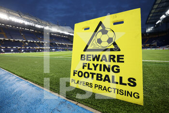 2023-03-07 - A sign reading “Beware Flying Footballs” is on display inside the stadium ahead of the match - CHELSEA FC VS BORUSSIA DORTMUND - UEFA CHAMPIONS LEAGUE - SOCCER