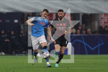 2023-04-12 - Olivier Giroud of AC Milan competes for the ball with Amir Rrahmani of SSC Napoli during UEFA Champions League 2022/23 Quarter-Finals - First  leg football match between AC Milan and SSC Napoli at San Siro Stadium, Milan, Italy on April 12, 2023 - AC MILAN VS SSC NAPOLI - UEFA CHAMPIONS LEAGUE - SOCCER