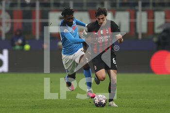 2023-04-12 - Sandro Tonali of AC Milan competes for the ball with Andre Anguissa of SSC Napoli during UEFA Champions League 2022/23 Quarter-Finals - First  leg football match between AC Milan and SSC Napoli at San Siro Stadium, Milan, Italy on April 12, 2023 - AC MILAN VS SSC NAPOLI - UEFA CHAMPIONS LEAGUE - SOCCER