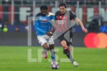 2023-04-12 - Sandro Tonali of AC Milan competes for the ball with Andre Anguissa of SSC Napoli during UEFA Champions League 2022/23 Quarter-Finals - First  leg football match between AC Milan and SSC Napoli at San Siro Stadium, Milan, Italy on April 12, 2023 - AC MILAN VS SSC NAPOLI - UEFA CHAMPIONS LEAGUE - SOCCER