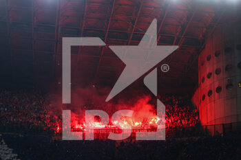 2023-04-19 - SL Benfica supporters light flares during the UEFA Champions League 2022/23 Quarter-Finals - 2nd leg football match between FC Internazionale and SL Benfica at Giuseppe Meazza Stadium, Milan, Italy on April 19, 2023 - INTER - FC INTERNAZIONALE VS BENFICA - UEFA CHAMPIONS LEAGUE - SOCCER