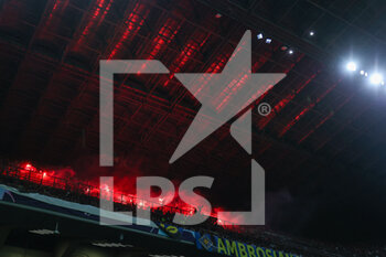 2023-04-19 - SL Benfica supporters light flares during the UEFA Champions League 2022/23 Quarter-Finals - 2nd leg football match between FC Internazionale and SL Benfica at Giuseppe Meazza Stadium, Milan, Italy on April 19, 2023 - INTER - FC INTERNAZIONALE VS BENFICA - UEFA CHAMPIONS LEAGUE - SOCCER