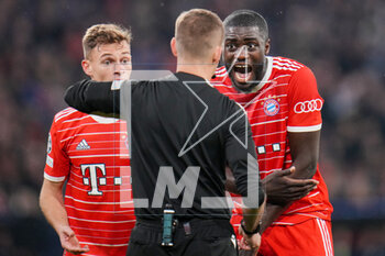 2023-04-19 - Referee Clement Turpin shows a yellow card to Dayot Upamecano of Bayern Munich during the UEFA Champions League, Quarter-finals, 2nd leg football match between Bayern Munich and Manchester City on 19 April 2023 at Allianz Arena in Munich, Germany - FOOTBALL - CHAMPIONS LEAGUE - BAYERN MUNICH V MANCHESTER CITY - UEFA CHAMPIONS LEAGUE - SOCCER