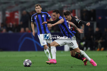 2023-05-10 - Hakan Calhanoglu of FC Internazionale competes for the ball with Brahim Diaz of AC Milan during UEFA Champions League 2022/23 Semi-Final 1st  leg football match between AC Milan and FC Internazionale at San Siro Stadium, Milan, Italy on May 10, 2023 - SEMIFINAL - AC MILAN VS INTER - FC INTERNAZIONALE - UEFA CHAMPIONS LEAGUE - SOCCER