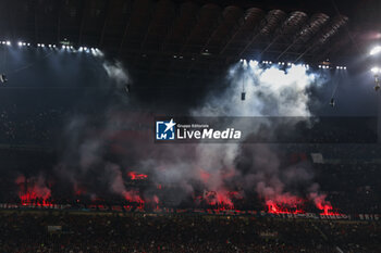 2023-05-10 - AC Milan supporters use smoke flares during UEFA Champions League 2022/23 Semi-Final 1st  leg football match between AC Milan and FC Internazionale at San Siro Stadium, Milan, Italy on May 10, 2023 - SEMIFINAL - AC MILAN VS INTER - FC INTERNAZIONALE - UEFA CHAMPIONS LEAGUE - SOCCER