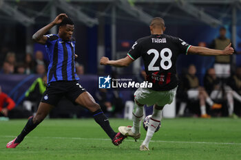 2023-05-16 - Denzel Dumfries of FC Internazionale competes for the ball with Malick Thiaw of AC Milan during the UEFA Champions League 2022/23 Semi-Final second leg football match between FC Internazionale and AC Milan at Giuseppe Meazza Stadium, Milan, Italy on May 16, 2023 - SEMIFINAL - INTER - FC INTERNAZIONALE VS AC MILAN - UEFA CHAMPIONS LEAGUE - SOCCER