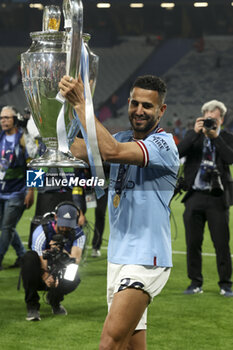 2023-06-10 - Riyad Mahrez of Manchester City celebrates with the trophy following the UEFA Champions League Final football match between Manchester City FC and FC Internazionale (Inter Milan) on June 10, 2023 at Ataturk Olympic Stadium in Istanbul, Turkey - FOOTBALL - CHAMPIONS LEAGUE - FINAL - MANCHESTER CITY V INTERNAZIONALE - UEFA CHAMPIONS LEAGUE - SOCCER
